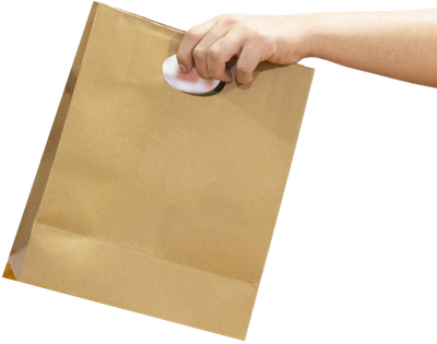 A hand holding a paper bag